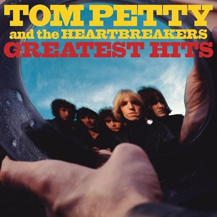 Tom Petty and The Heartbreakers Greatest Hits album cover featuring the band with a blue backdrop.