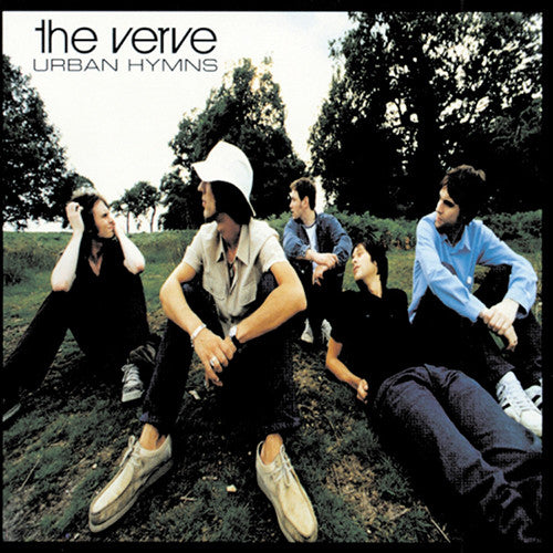 The cover image features a group of people, likely members of the band The Verve, sitting on grass in a park with trees in the background. They are wearing casual clothing and appear to be looking off to the distance.