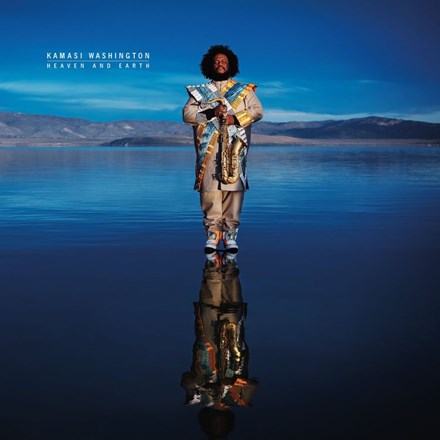 Cover art for Kamasi Washington's album Heaven and Earth featuring the artist standing by a body of water with a reflective surface.