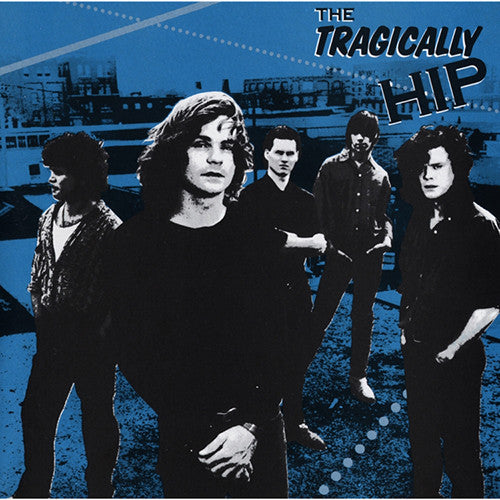 The product image features the album cover of 'The Tragically Hip' by the band The Tragically Hip. The cover art presents a blue-toned photograph of the band members with a backdrop suggesting a industrial setting, possibly a loading area or dock.