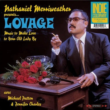 The image shows the album cover of 'Nathaniel Merriweather Presents Lovage Avec Michael Patton– Music To Make Love To Your Old Lady By' with a turquoise vinyl record label at the top. The cover features a man in a suit with a pipe, sitting at a table with roses and a gun.
