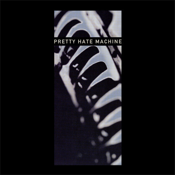 This image features the cover art for the 2010 remaster of Nine Inch Nails' album "Pretty Hate Machine." The artwork is strikingly atmospheric, showcasing a blurred, abstract image of a keyboard or synthesizer, possibly suggesting the album's dark and electronic sound.