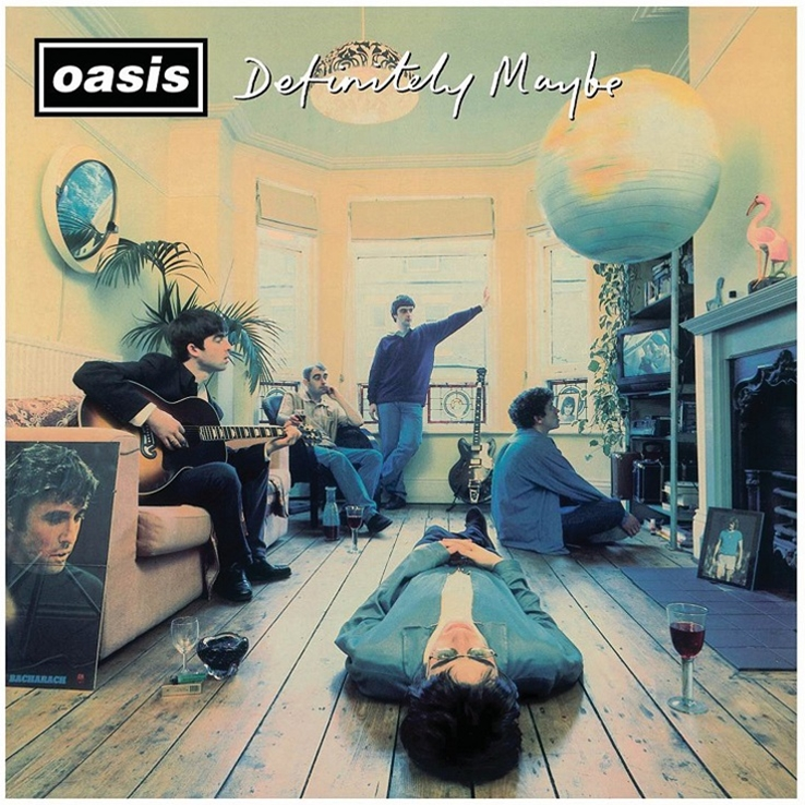 The album cover of Oasis' 'Definitely Maybe' featuring a photograph of the band members in a casual indoor setting, with a vinyl record layout in the foreground.