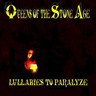 Album cover for Queens of the Stone Age - Lullabies to Paralyze featuring a person holding a candle in a dark setting, with the band's name and album title.