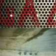 Album cover art for Fugazi's Red Medicine LP featuring a close-up of a metallic grid with a reflection.