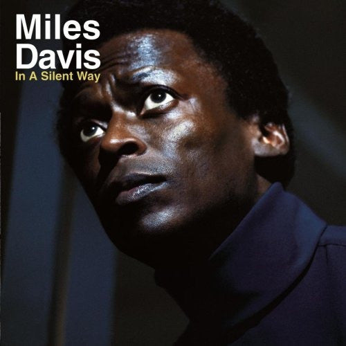 Album cover of Miles Davis - In A Silent Way featuring a photograph of Miles Davis with dark tones and a serious expression.