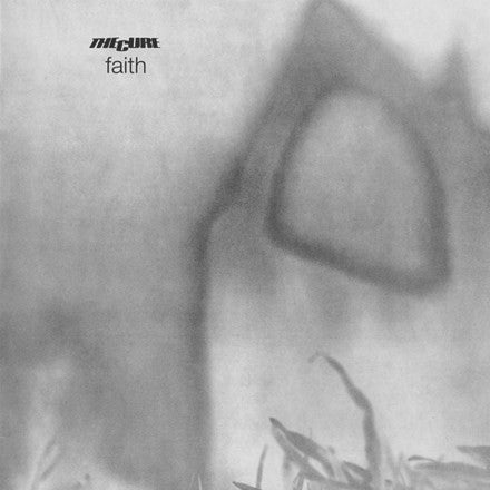 This image features the album cover for "Faith" by The Cure, a classic track from the postpunk outfit's gothic period. The cover art is strikingly atmospheric, displaying a blurred, monochrome photo of a building or house, conveying a sense of loss and melancholy.