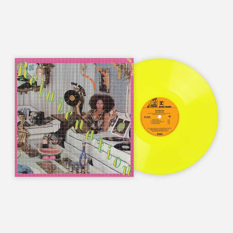 Vinyl record with a colorful cover featuring a woman and text, on a white background.