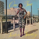 Album cover with a woman standing on a dock, featuring the text 'One Two Sister Nancy'.