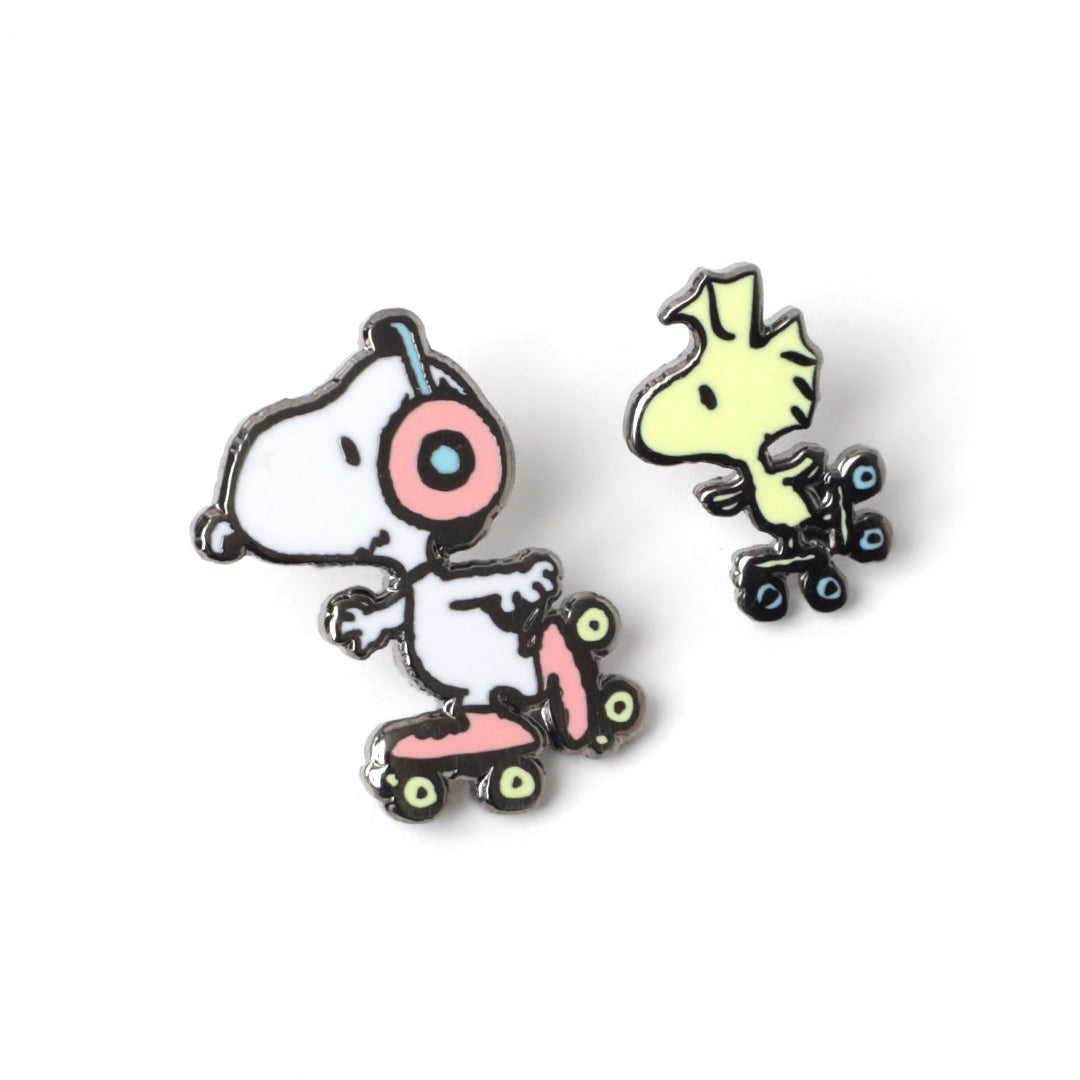 Two cartoon character pins on a white background