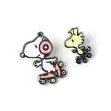 Two cartoon character pins on a white background