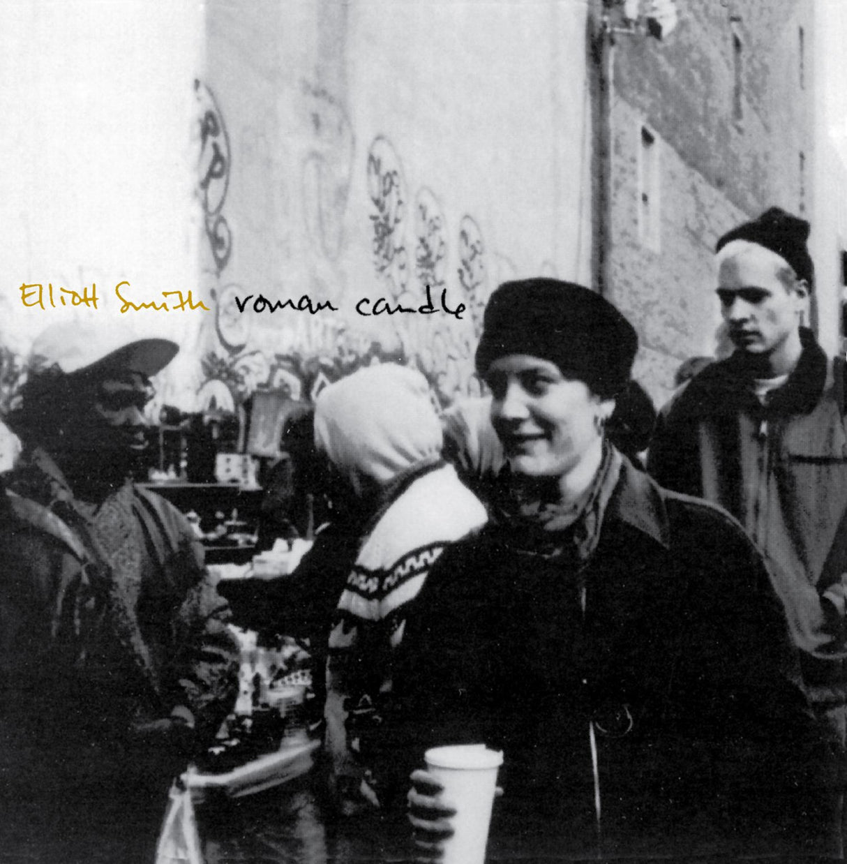 Album cover with black and white photo of people and text 'Elliot Smith Roman Candle'.