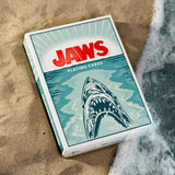Jaws playing cards packaging on sand with shark illustration