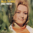 Album cover for Dolly Parton's 'Hello, I'm Dolly' featuring a close-up portrait of Dolly Parton with blonde hair, wearing an orange turtleneck and white jacket, set against a soft-focus green outdoor background. The text 'HELLO, I'M DOLLY' is in yellow, and 'DOLLY PARTON' is in white.