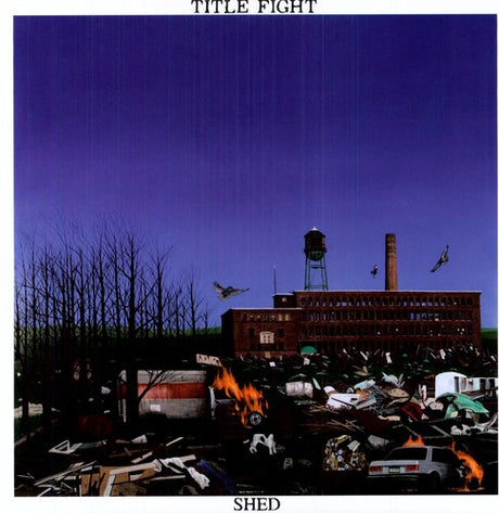This image features the album cover for "Shed" by Title Fight, a debut full-length LP set in Kingston, PA. The cover depicts a desolate, post-apocalyptic scene with a large, old factory building at the center, surrounded by rubble and debris, including burnt-out cars and a fire hydrant.