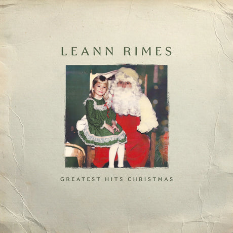 Album cover featuring a woman and Santa Claus with text 'Leann Rimes Greatest Hits Christmas' on a textured background.