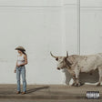 Woman in a cowboy hat standing next to a cow against a white wall with a 'Parental Advisory' label.