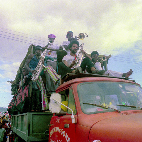 People with musical instruments on a truck in a colorful setting