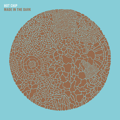 Album cover with intricate brown pattern on a light blue background, featuring the text 'Hot Chip Made in the Dark'.