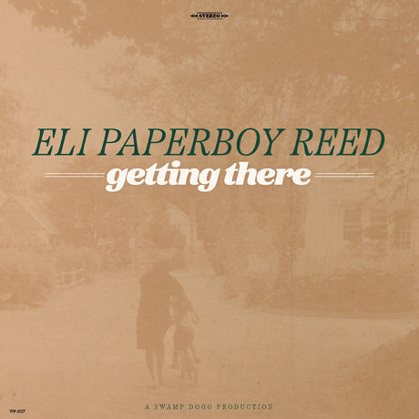Album cover for 'getting there' by Eli Paperboy Reed with a sepia-toned scene of a person walking a dog.