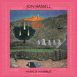 Jon Hassell 'Music Is Invisible' CD cover featuring a surreal landscape artwork with a glowing orange mountain, stone structures, a dark tree with bright light bursts, and a pink patterned border.