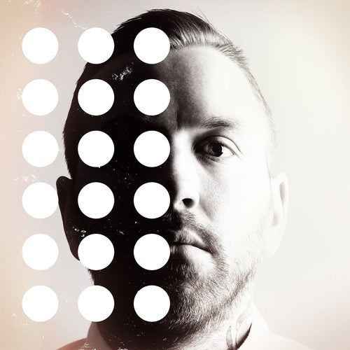 Man with a stylized face design featuring white circles on a light background