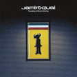 The image features the album cover of "Travelling Without Moving" by Jamiroquai, which is a 2LP record. The cover art displays a distinctive design with a silhouette of a figure against a vibrant yellow background, contained within a black record sleeve.
