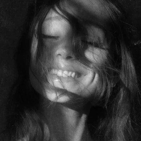 Black and white close-up of a person with long hair.