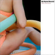 Close-up of a person holding a colorful tube with 'No Home Record' and 'Kim Gordon' text.