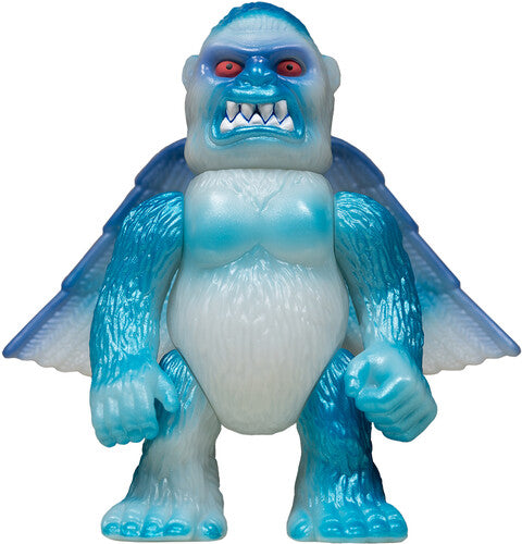 Toy figure of a blue and white creature with red eyes on a white background