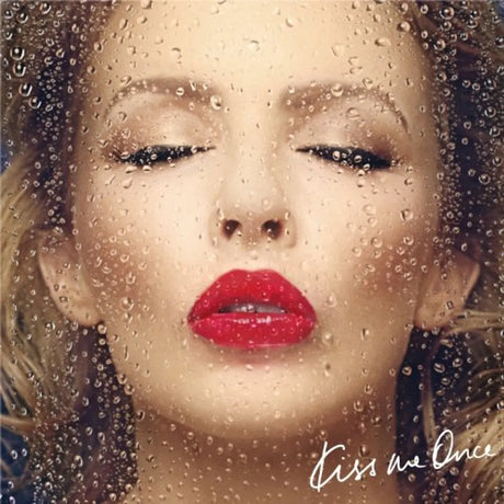 Album cover with a woman's face through raindrops, featuring red lipstick.