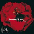 Album cover art for 'Adore' featuring a woman in a red dress spread out like petals on a large red flower against a black background, with the word 'Adore' in white script at the bottom left.