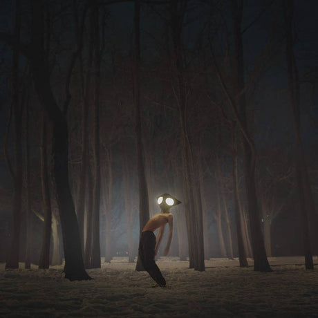 Person with glowing eyes in a dark forest