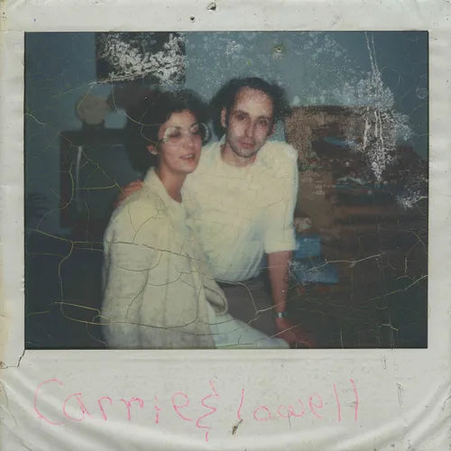 Vintage photograph of a couple sitting together with visible wear and tear.