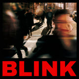 Blurred city street scene with people crossing a crosswalk, featuring the word 'BLINK' in red text.