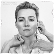Black and white album cover with a person adjusting an earring, featuring the text 'Brandi Carlile Returning to Myself'.