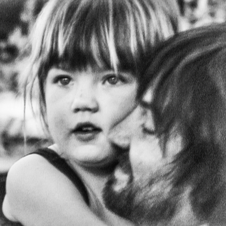 Black and white photo of a child being held by an adult