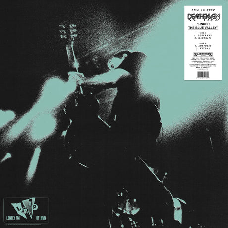 Vinyl record cover with a person playing guitar, featuring text and logos on a black and white background.
