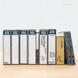 Collection of vintage audio cassettes with labels on a white background