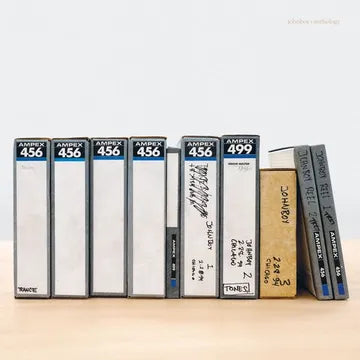Collection of vintage audio cassettes with labels on a white background
