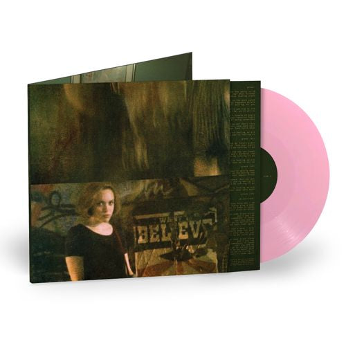 Vinyl record with a pink disc and cover featuring a person and text.