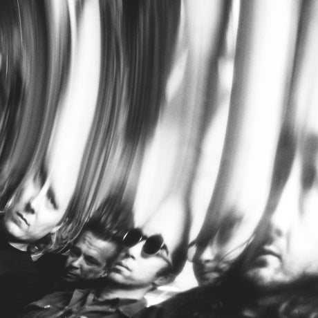 Black and white artistic photograph of multiple distorted, mirrored reflections of a man's face and profile, creating a high-contrast abstract composition.