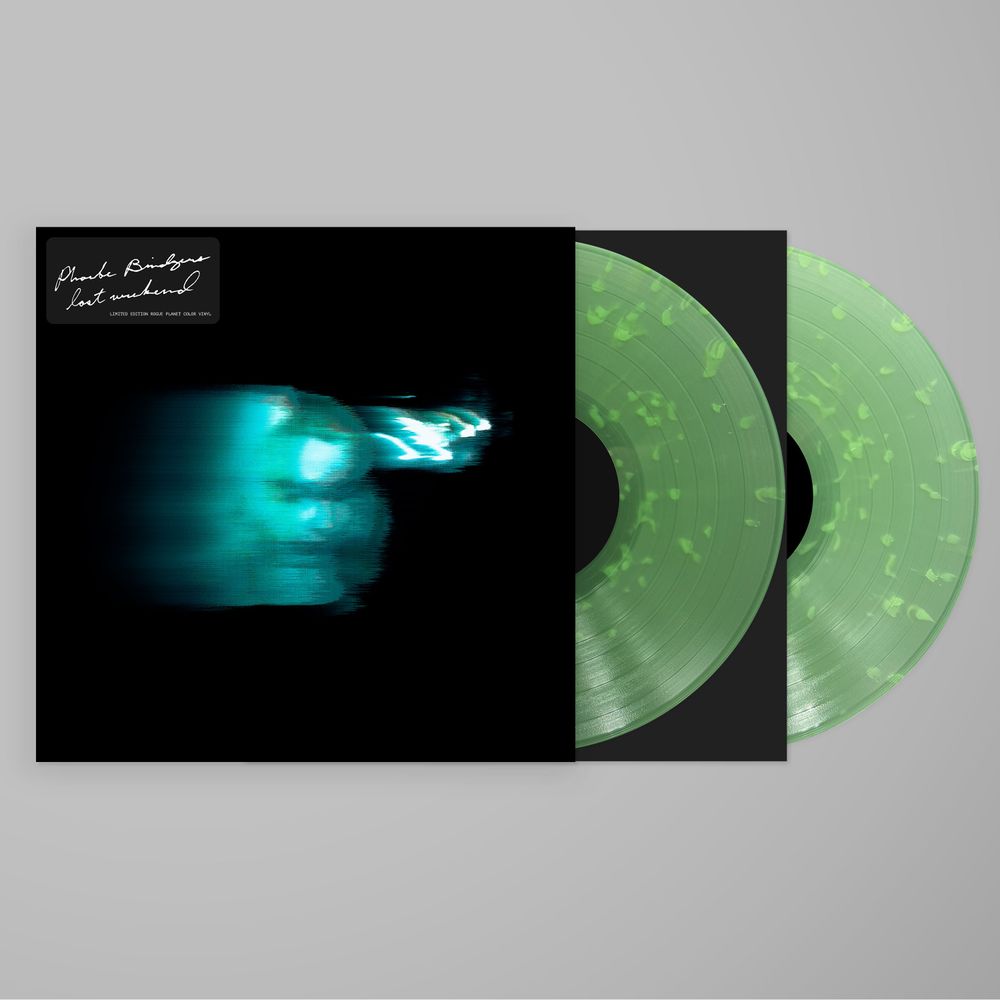 Vinyl record with green marbled design and black cover on a gray background