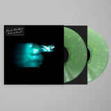 Vinyl record with green marbled design and black cover on a gray background