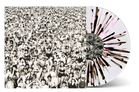 A vinyl record album with a black-and-white crowd photograph on the cover and a translucent white record featuring dark radial streaks and pink splatter, shown on a light gray background.