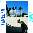 A vinyl record titled 'Anri - Timely!!' with a tropical-themed cover featuring palm trees and a woman leaning on a wall.