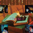 Album cover with open book, flames, and 'R.E.M.' logo on a wooden surface.