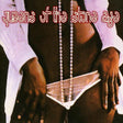 Album cover with 'queens of the stone age' text and a person holding a necklace.