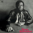 Album cover with a person wearing a leather jacket, sitting at a table, and 'Dom Salvador' text.