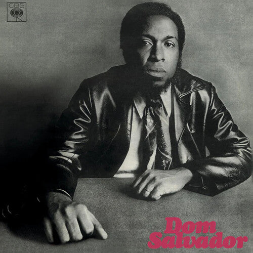 Album cover with a person wearing a leather jacket, sitting at a table, and 'Dom Salvador' text.